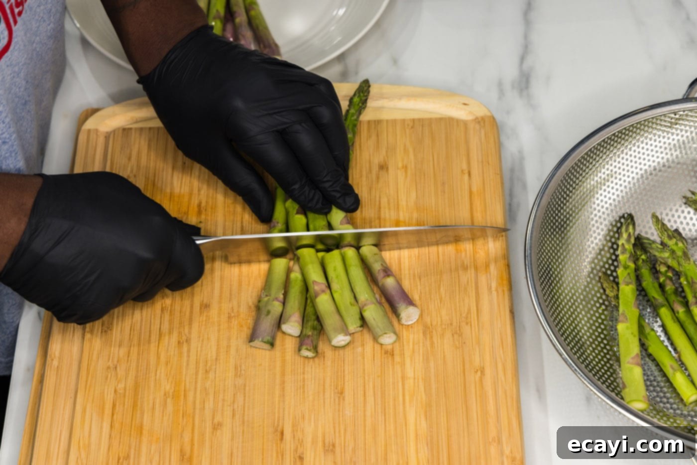 Golden Asparagus Crunch 5 cutting woody ends off asparagus spears