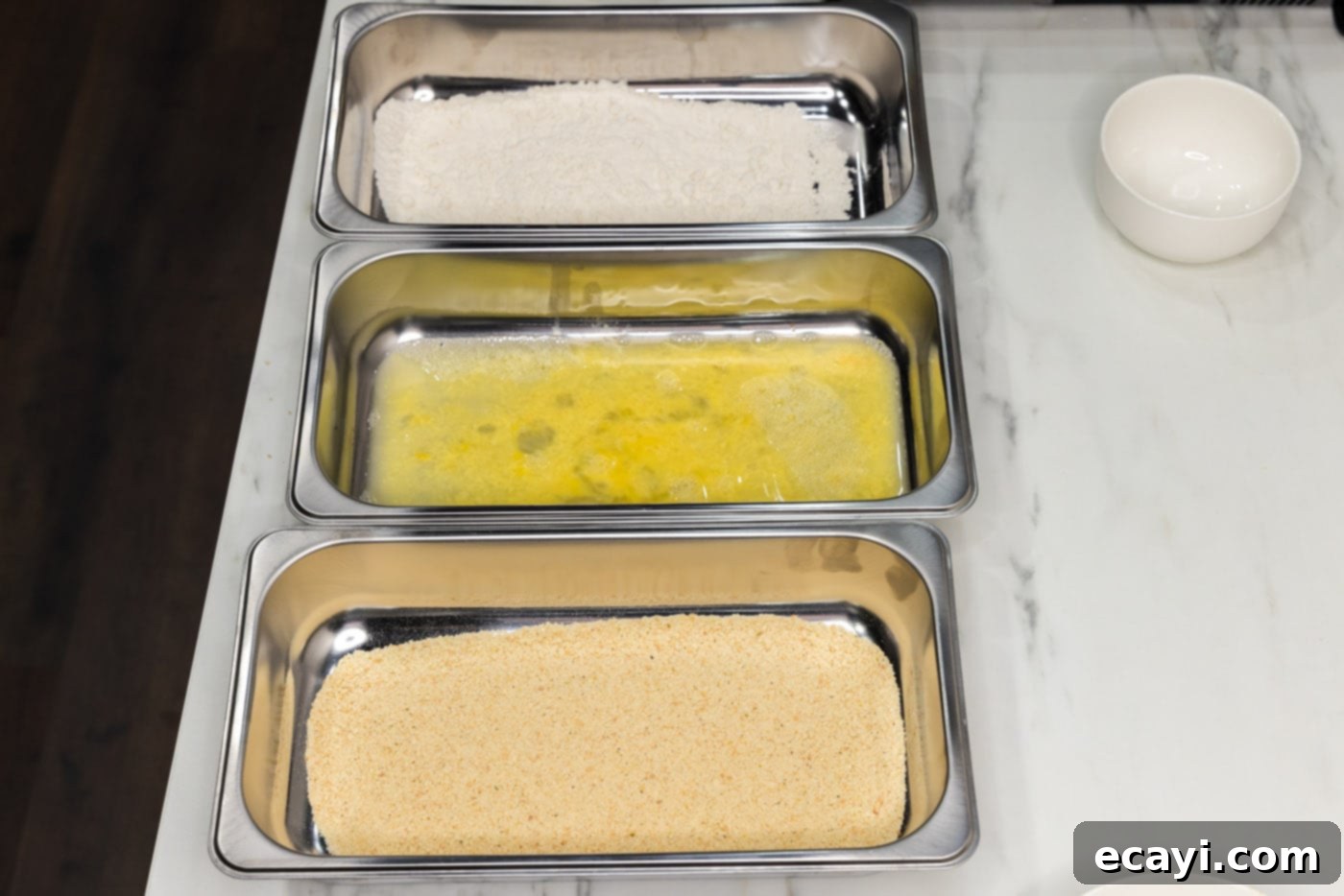 Golden Asparagus Crunch 7 dredging station on counter top with breadcrumbs