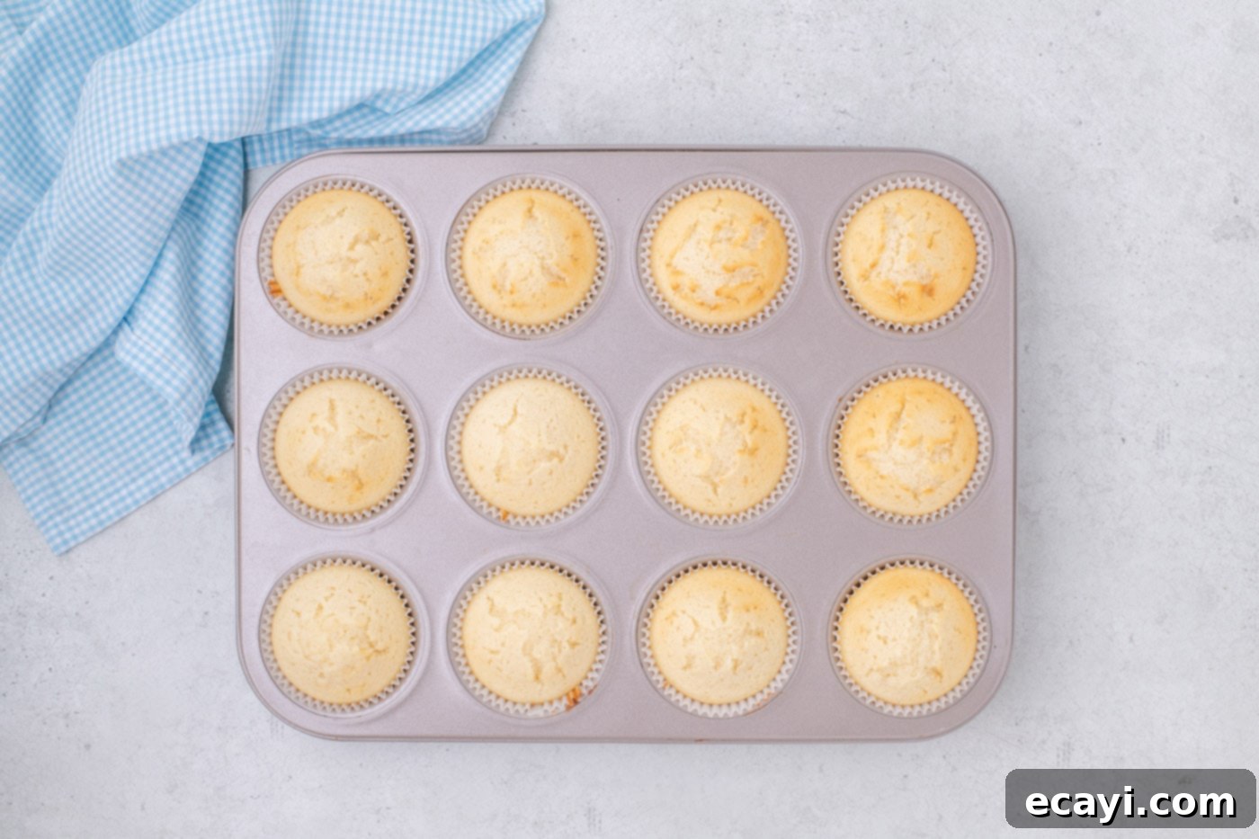 Vanilla Cupcakes 11 Perfectly baked golden vanilla cupcakes in a muffin pan