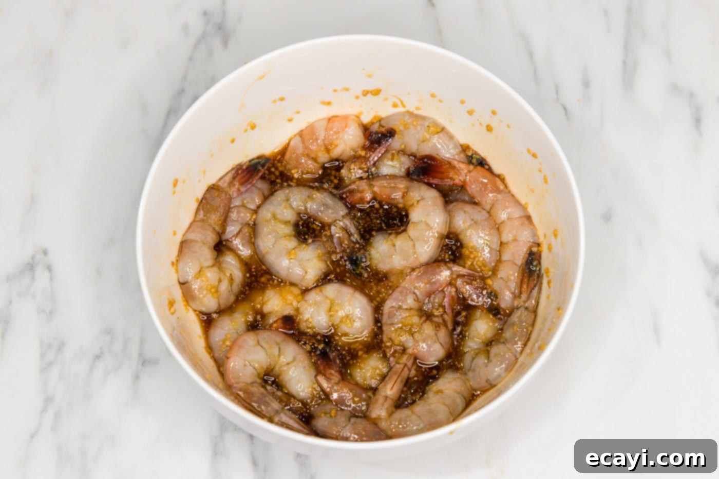 Glazed Honey Garlic Shrimp 7 honey garlic shrimp coated in sauce, ready for cooking