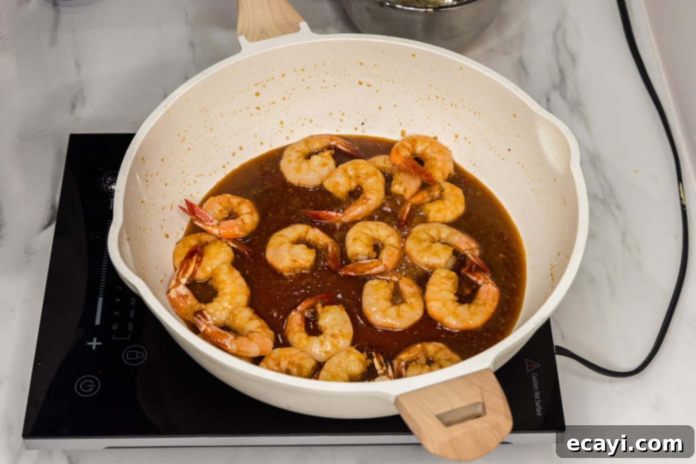 Glazed Honey Garlic Shrimp 10 finished honey garlic shrimp coated in a thick, glossy sauce in a skillet
