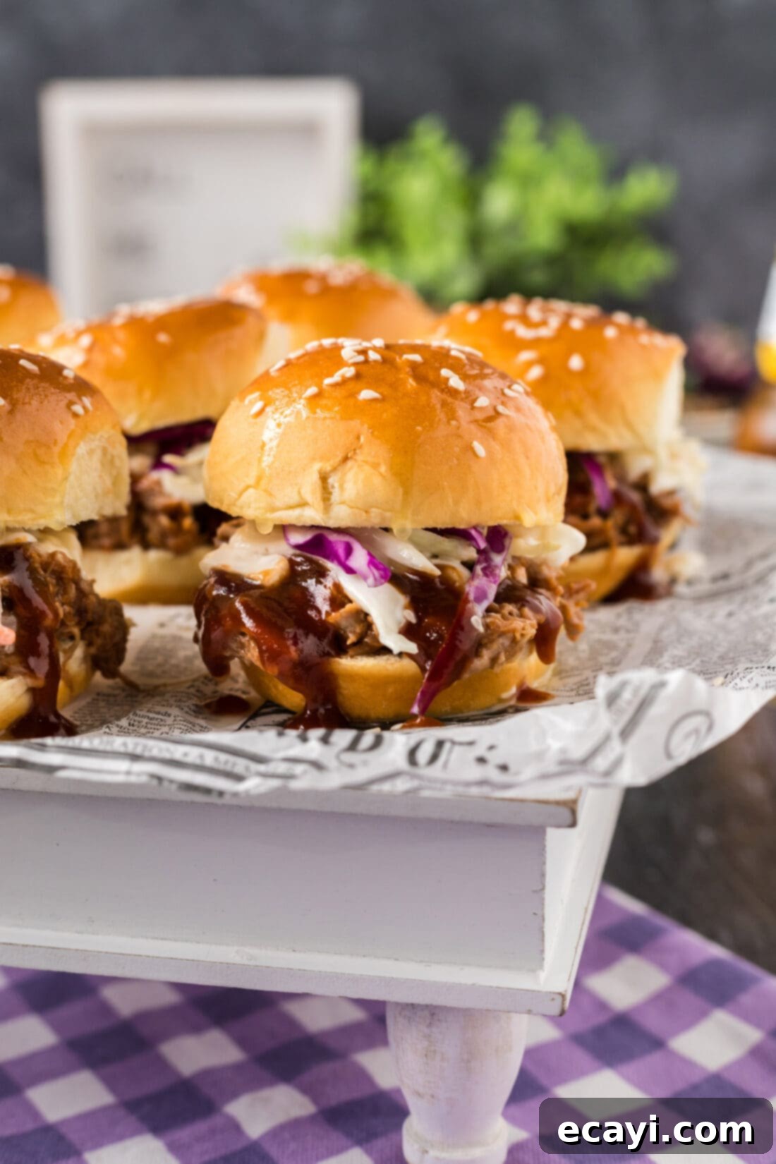 BBQ Pulled Pork Bites 3 Close up photo of a Pulled Pork Slider on a serving platter, showcasing the rich BBQ sauce and colorful coleslaw, ready to eat