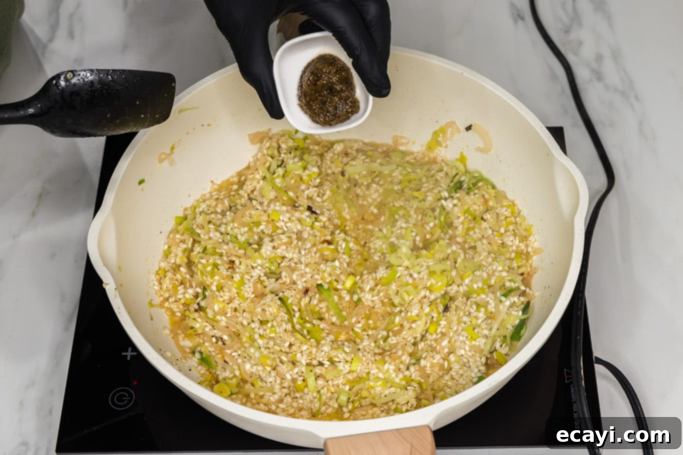 Velvet Asparagus Risotto 11 adding bouillon base to skillet with risotto