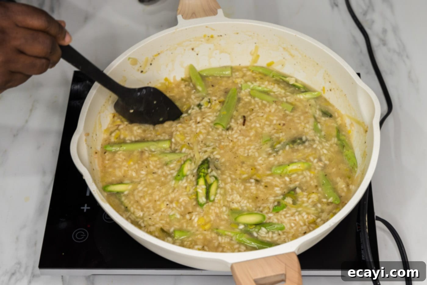 Velvet Asparagus Risotto 14 turning asparagus spears in a skillet with creamy risotto