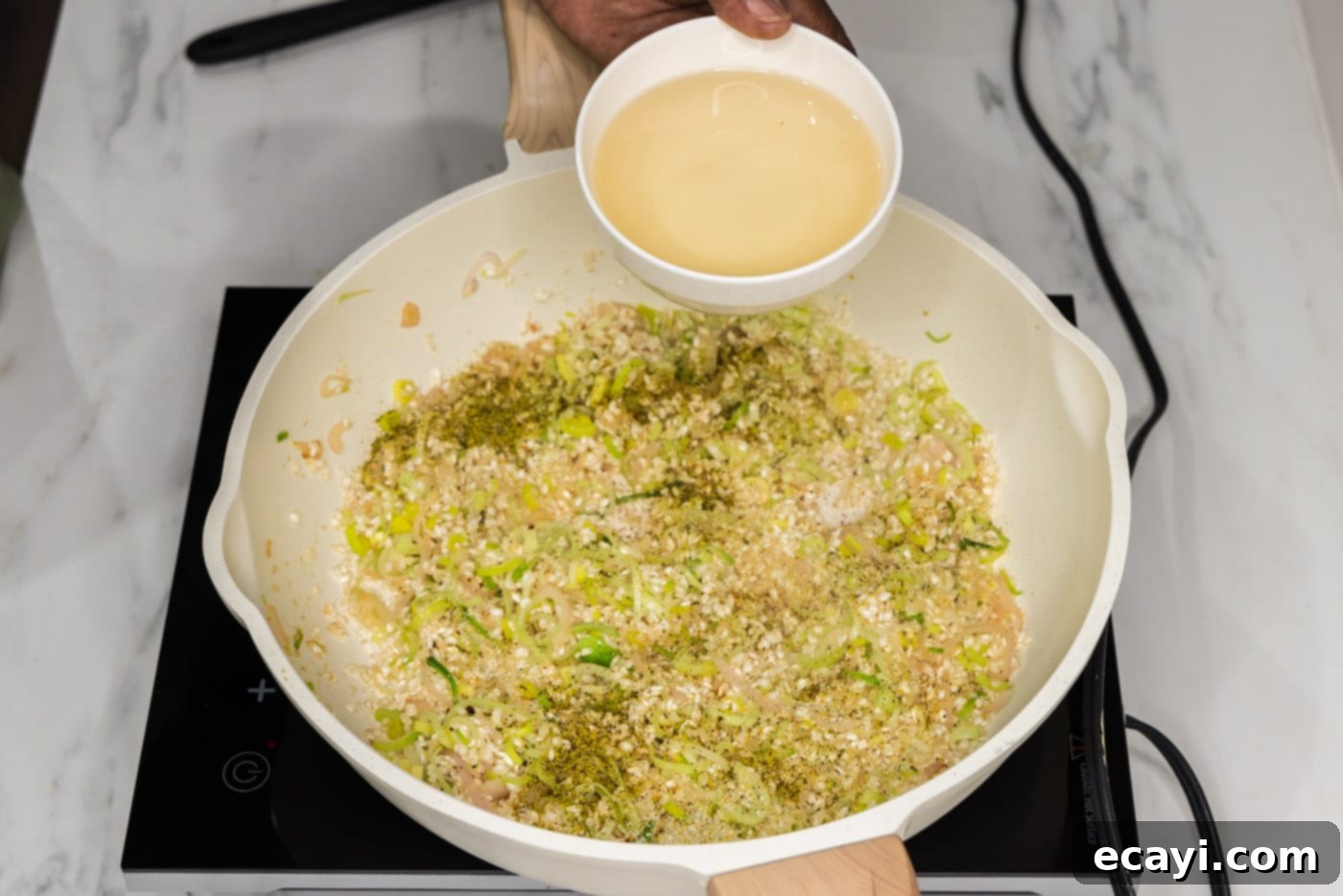 Velvet Asparagus Risotto 10 adding white wine to skillet with risotto mixture
