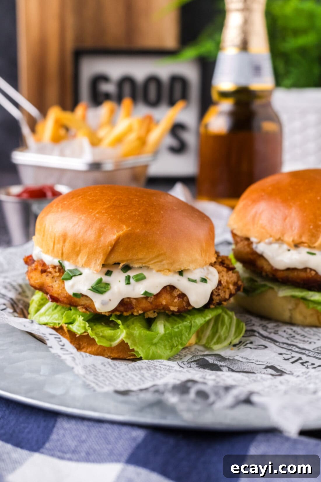 Crispy Fish Sandwich 2 Two Fish Burgers on a platter with fries in the background