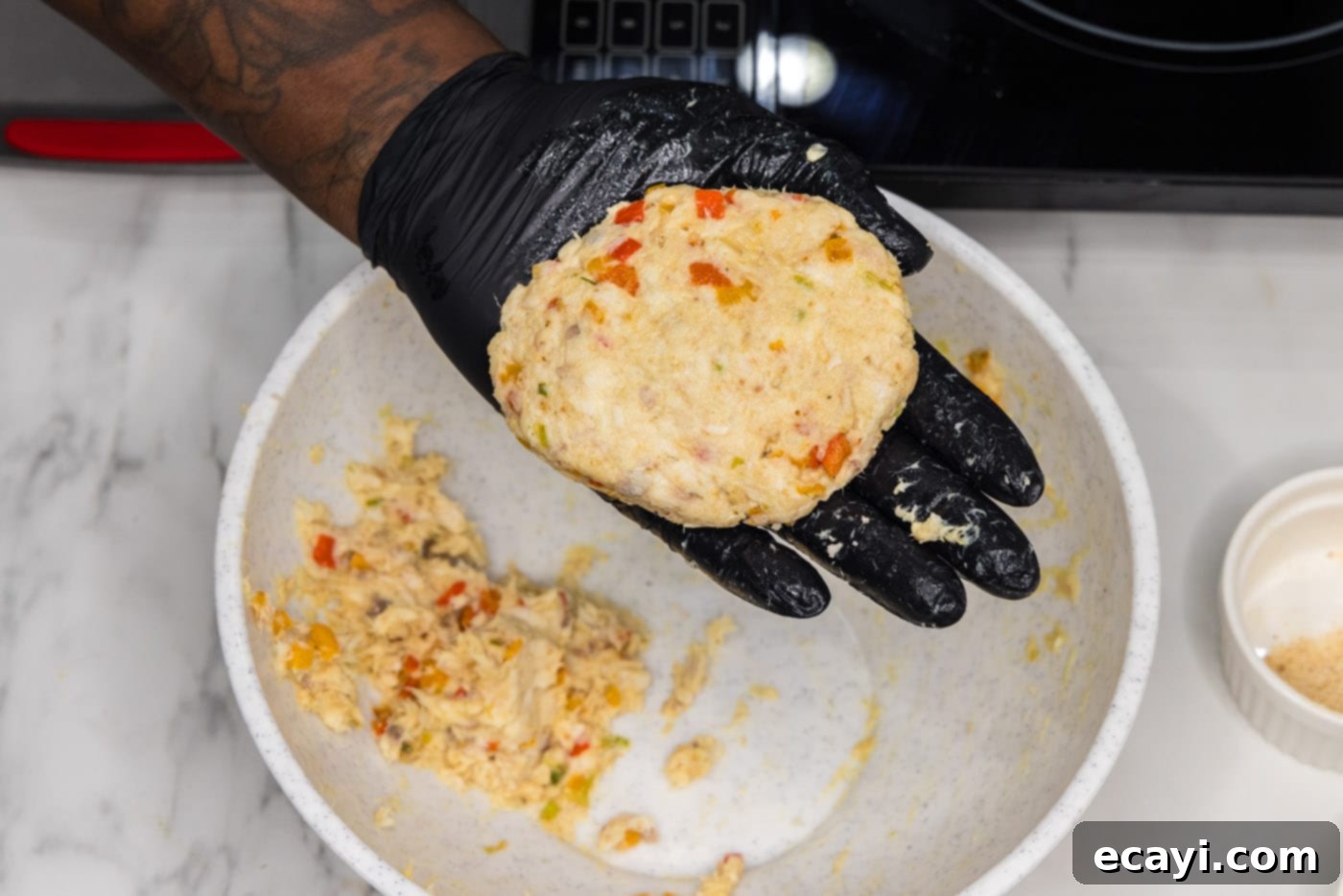 Crispy Fish Sandwich 10 forming fish mixture into a patty with gloved hands