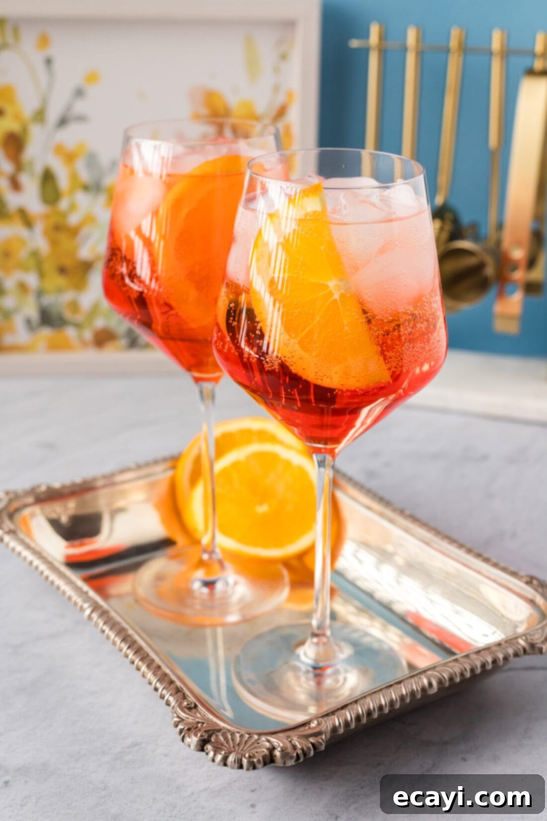 Golden Hour Aperol Spritz 8 Two Aperol Spritz cocktails on a sleek serving platter, ready to be enjoyed.