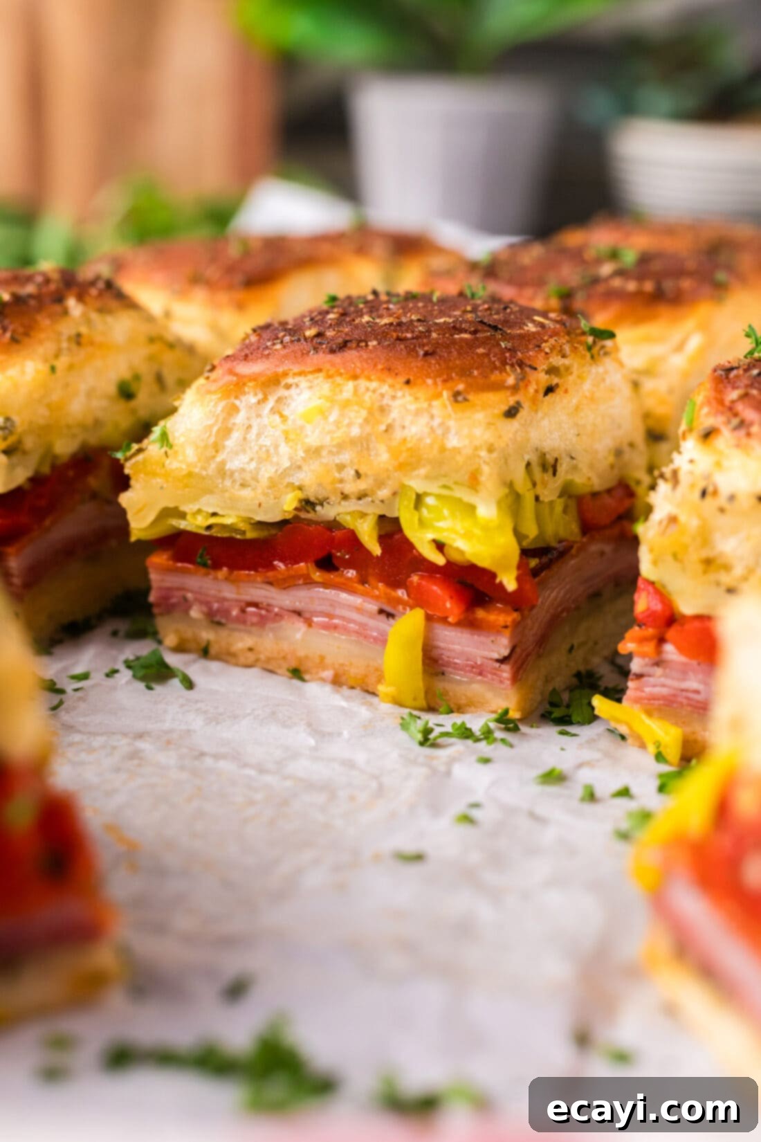Zesty Italian Sliders 5 Close up photo of Italian Sliders on parchment paper