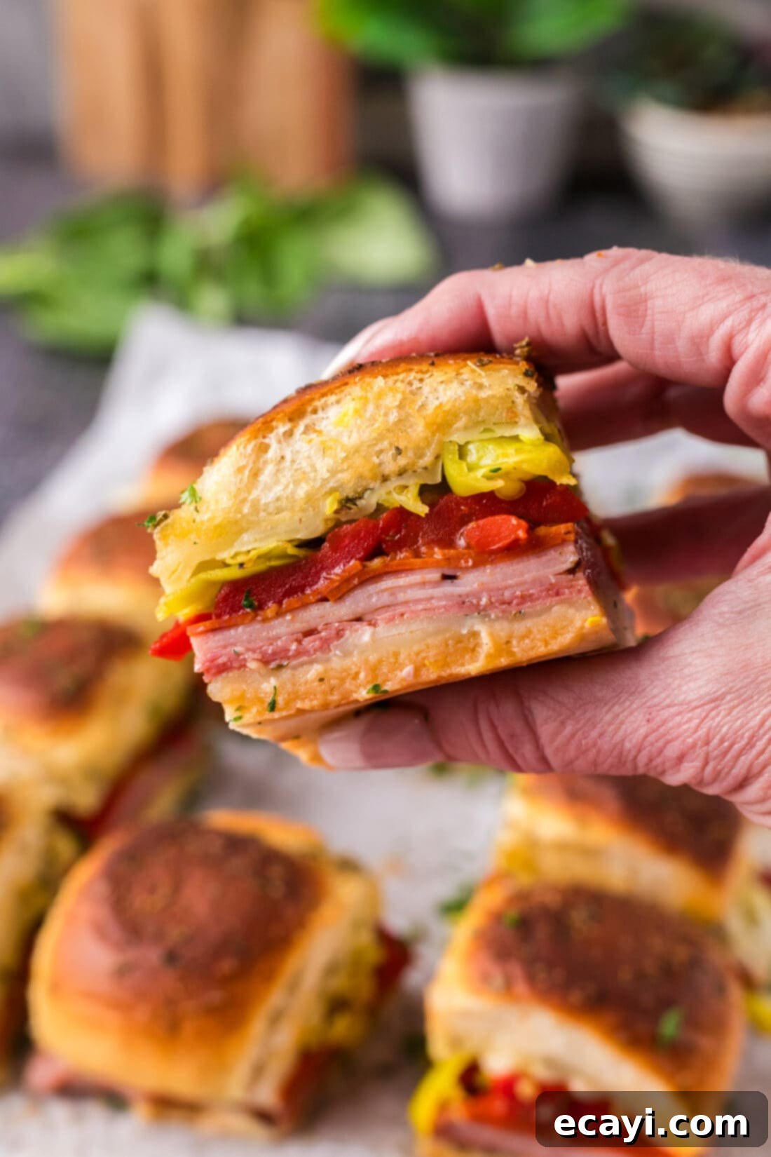 Zesty Italian Sliders 3 Hand holding up a Italian Slider