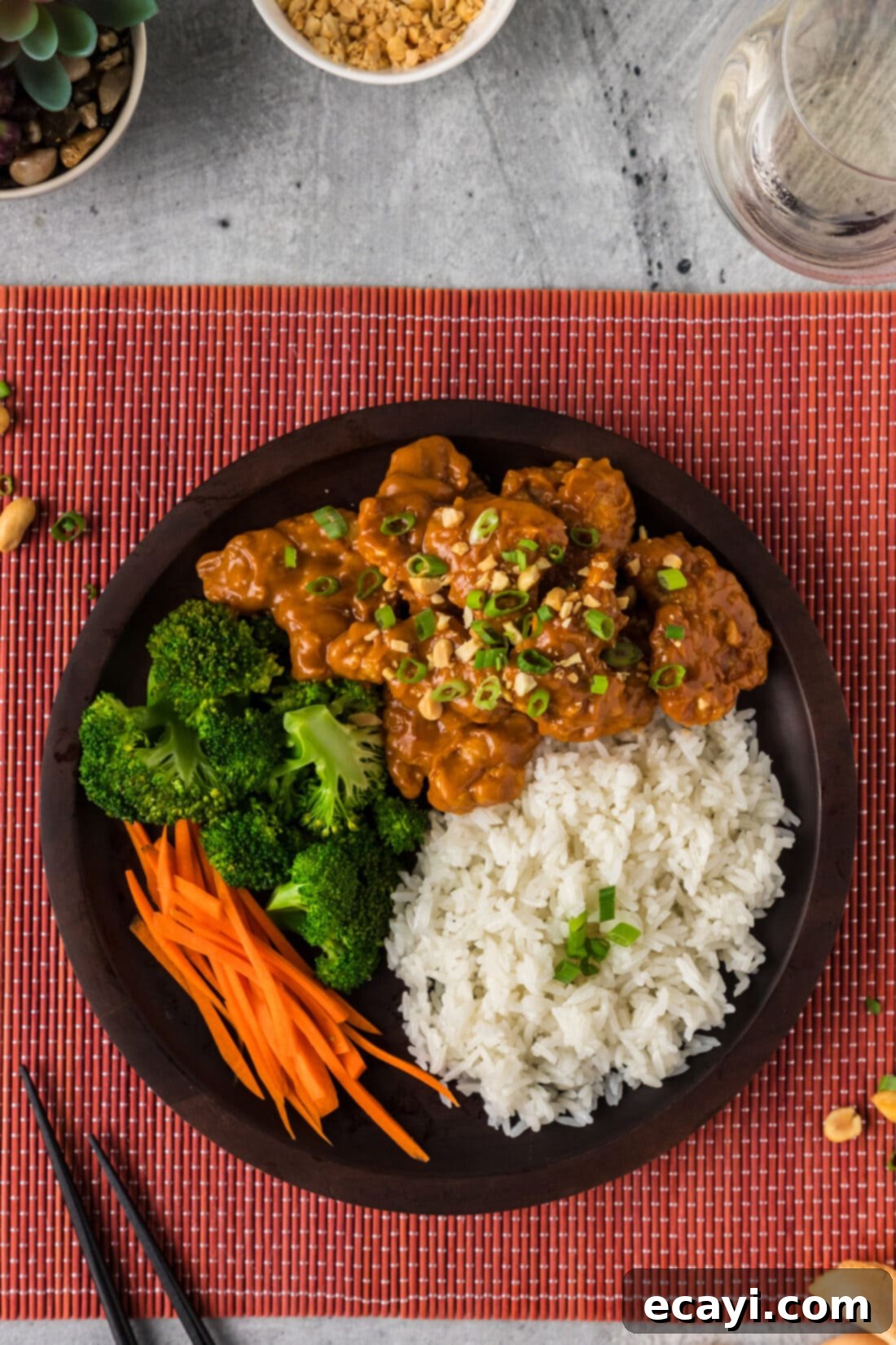 Creamy Peanut Butter Chicken 14 A beautifully plated dish of Peanut Butter Chicken served with steamed rice and green vegetables