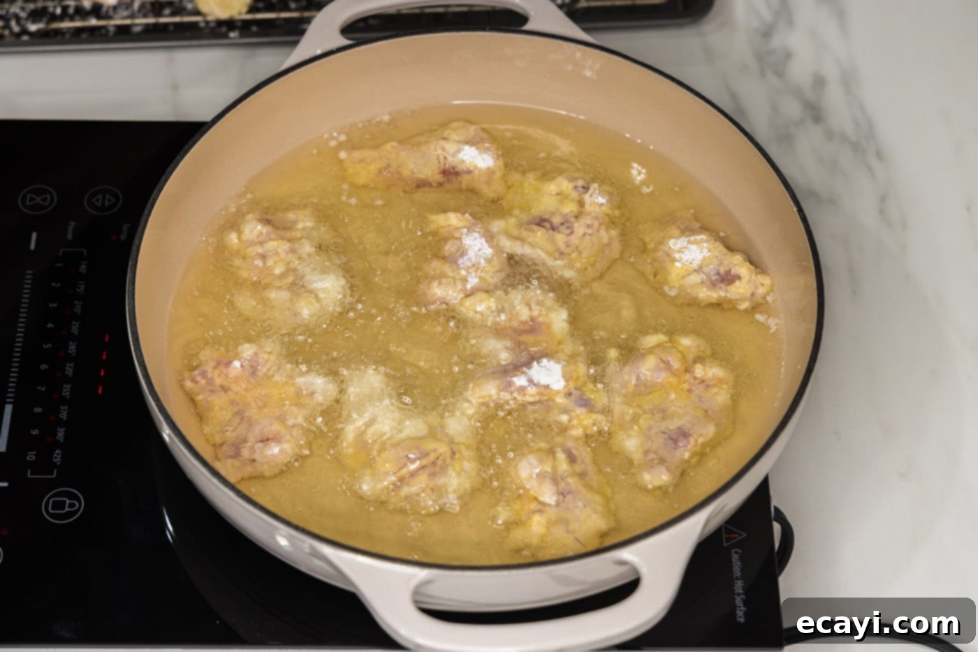 Creamy Peanut Butter Chicken 9 pan frying dredged chicken pieces until golden and crispy