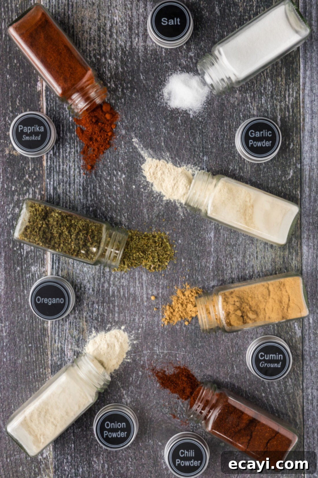 Fiesta Spice Blend 2 Spices jars needed for Mexican Seasoning spilled on a table