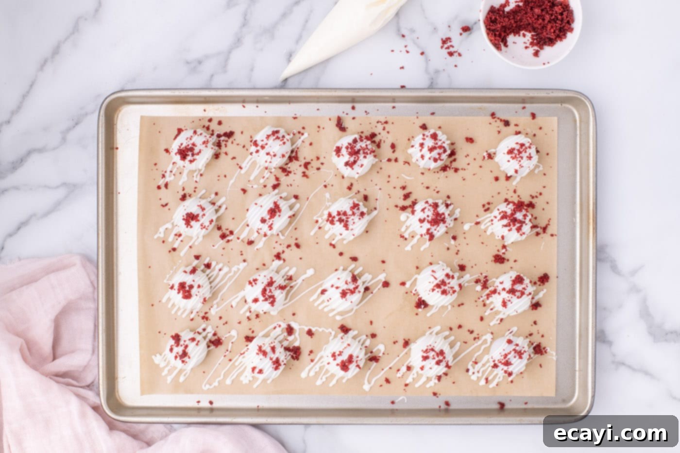 Red Velvet Truffles 14 Overhead view of finished red velvet cake balls arranged on a parchment-lined baking sheet.