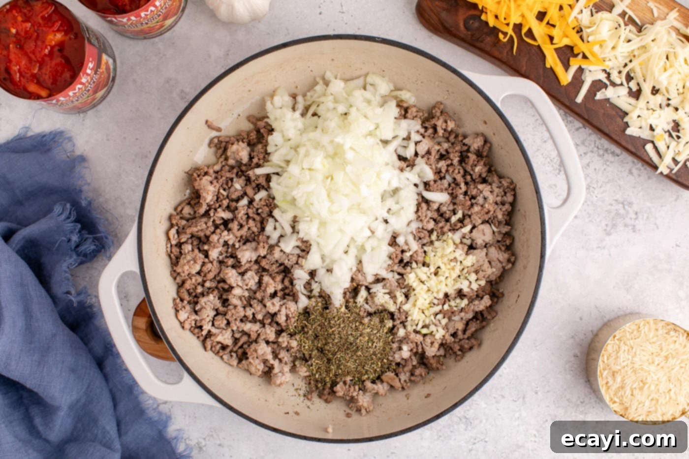 Deconstructed Stuffed Pepper Bake 6 Chopped onion, minced garlic, and Italian seasoning mixed into the browned ground beef and Italian sausage in a Dutch oven.
