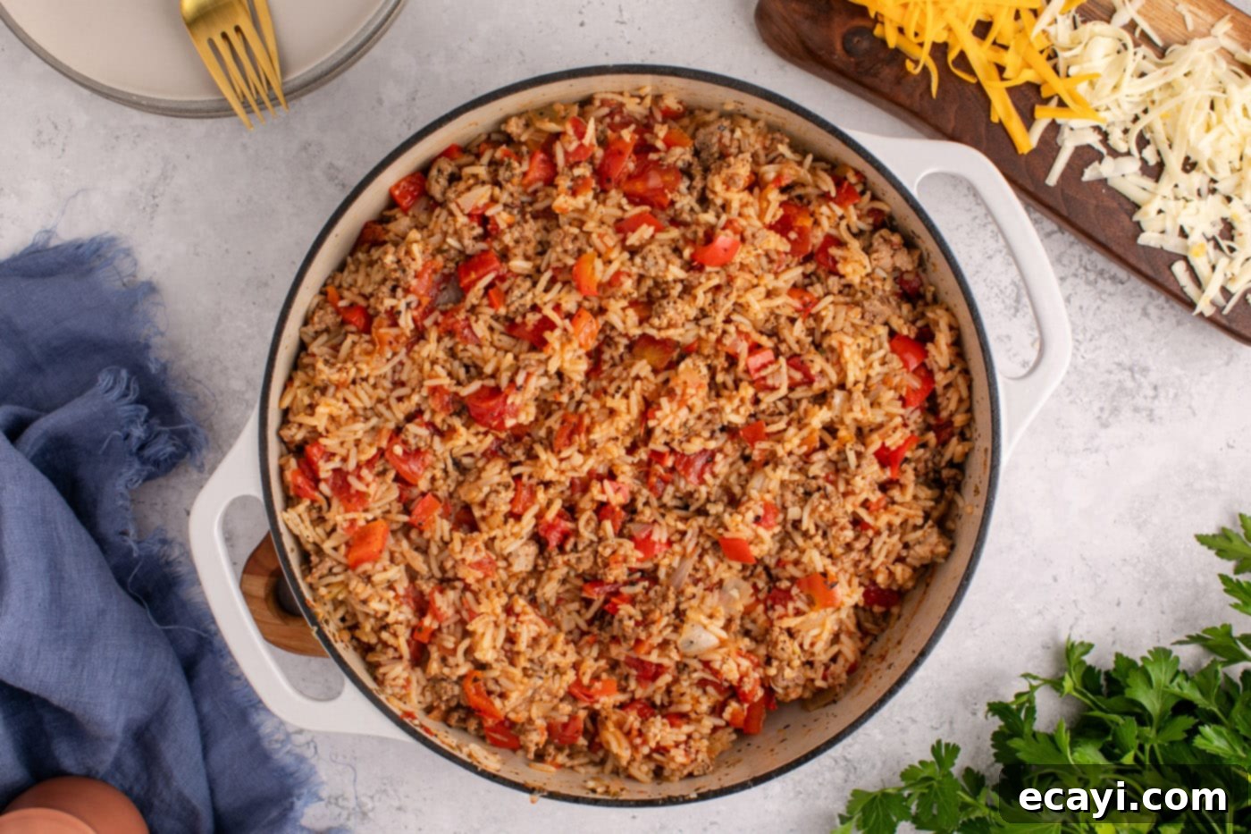 Deconstructed Stuffed Pepper Bake 9 Cooked stuffed pepper casserole in a Dutch oven, topped with shredded cheese before melting.