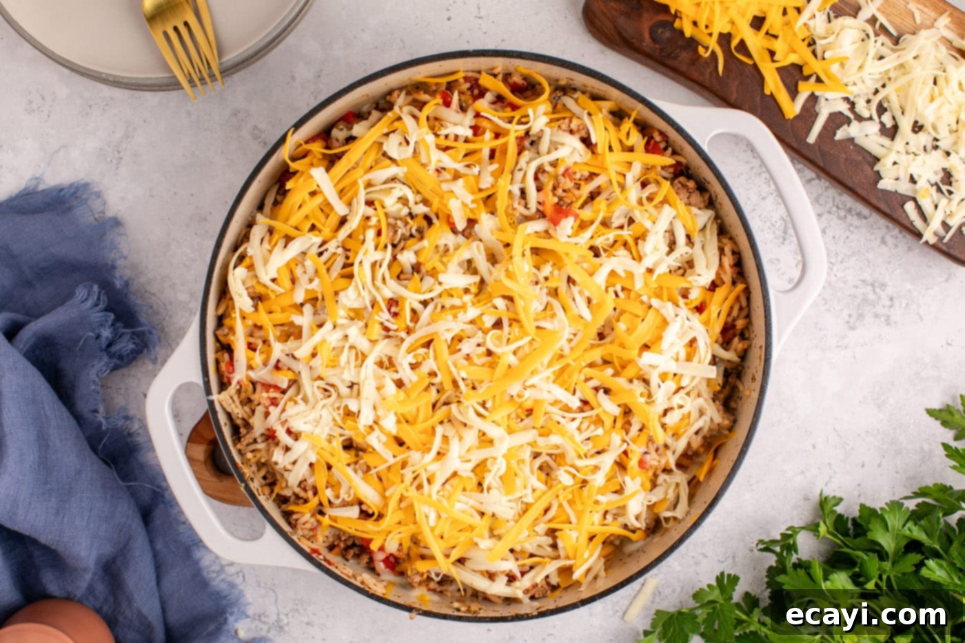 Deconstructed Stuffed Pepper Bake 10 Generous layer of shredded cheese melting on top of the stuffed pepper casserole in a Dutch oven.