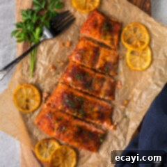 Artisan Smoked Salmon 11 Smoked Salmon fillets resting on parchment paper on a serving tray.