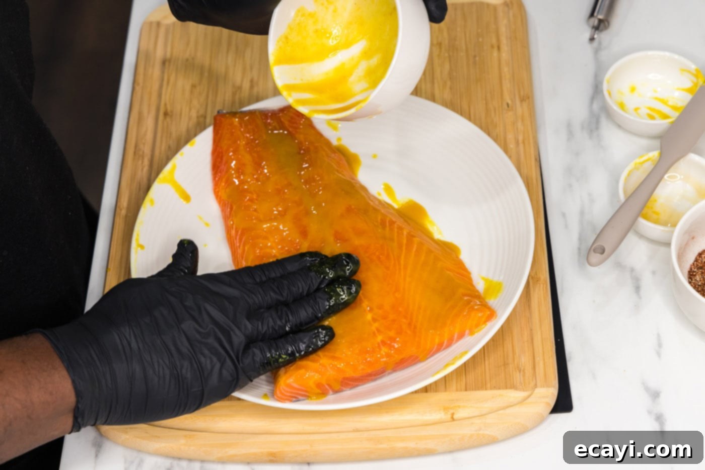 Artisan Smoked Salmon 5 Chef applying a honey-mustard rub onto a salmon filet with a brush