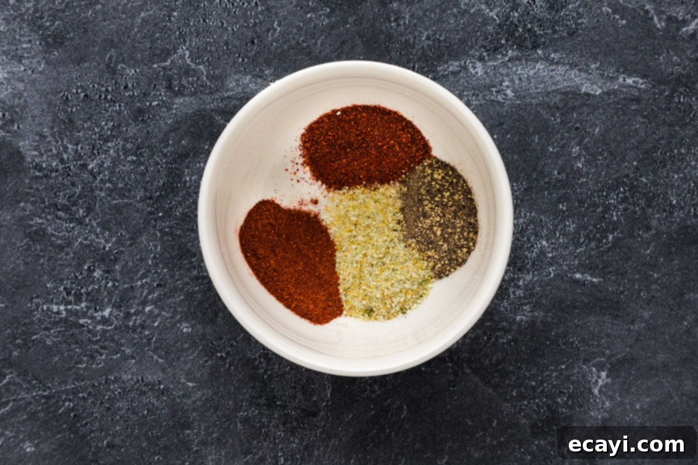 Artisan Smoked Salmon 6 Close-up of a bowl containing a blend of chili powder, paprika, garlic salt, and pepper.