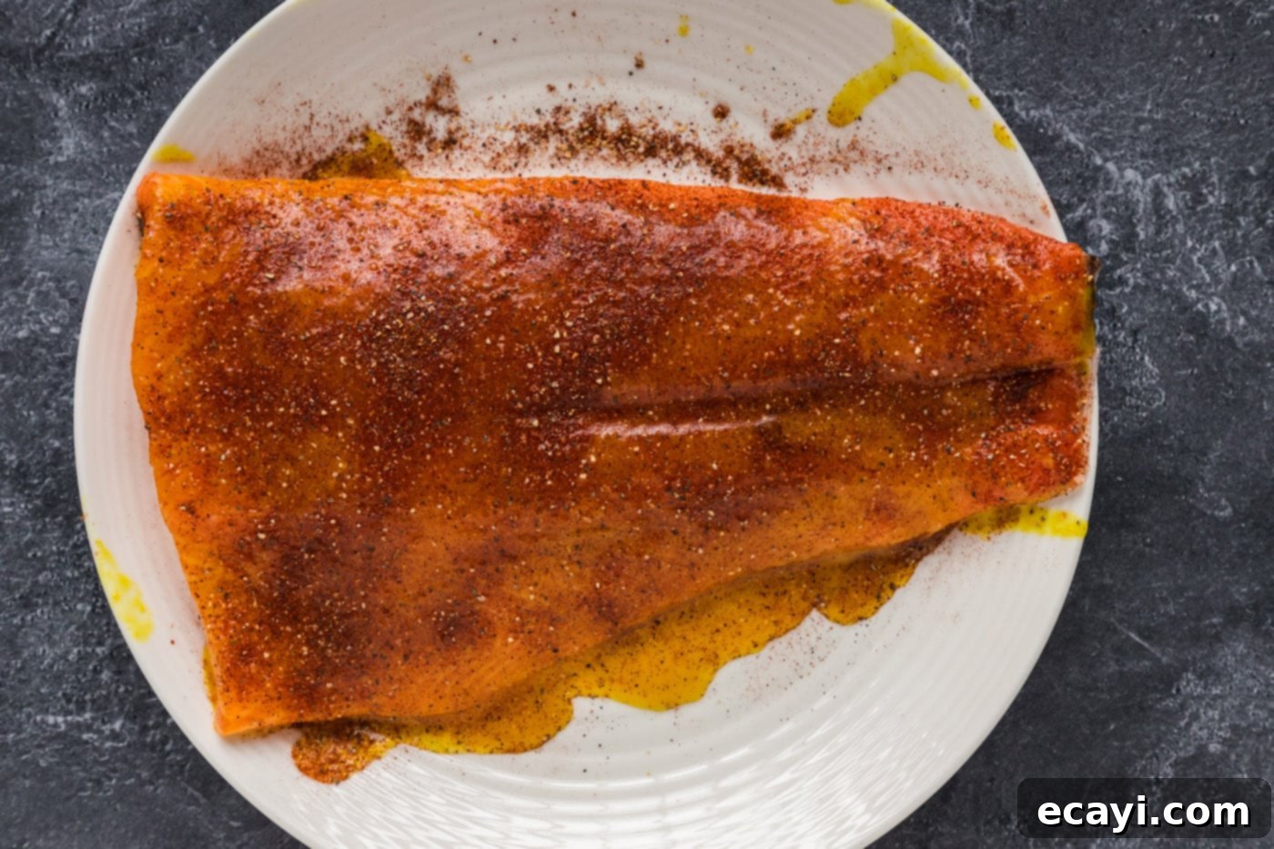 Artisan Smoked Salmon 7 A salmon filet, fully coated with a honey-mustard and spice rub, ready for smoking.