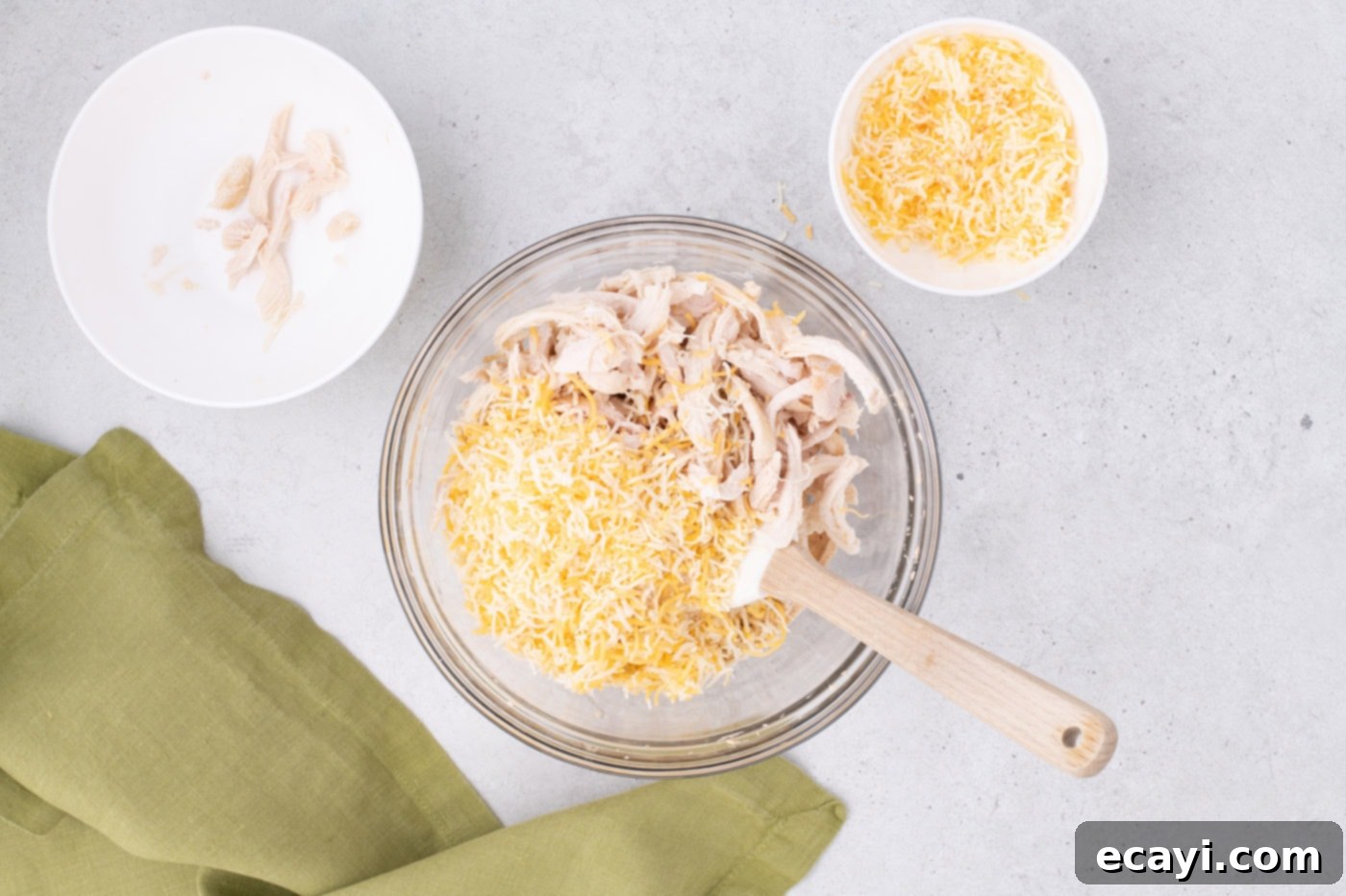 Southwest Swirls 7 adding shredded chicken and cheese to mexican pinwheel filling