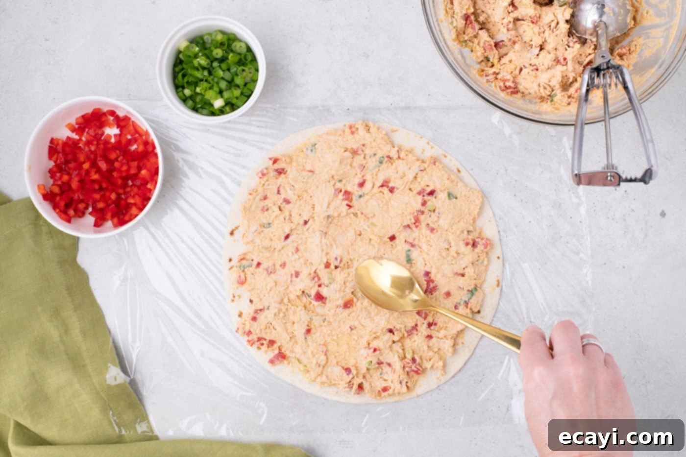 Southwest Swirls 10 spreading cream cheese taco filling over a burrito tortilla shell