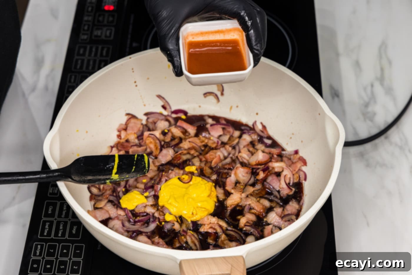 Sizzling Spicy Cabbage 6 Pouring hot sauce into the skillet with bacon, onion, garlic, and soy sauce, completing the spicy and savory sauce mixture.