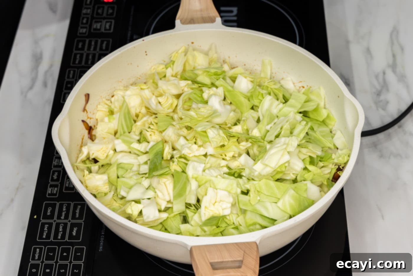 Sizzling Spicy Cabbage 7 Chopped green cabbage added to the skillet with the bacon, onion, garlic, and sauce mixture, ready to be stir-fried.