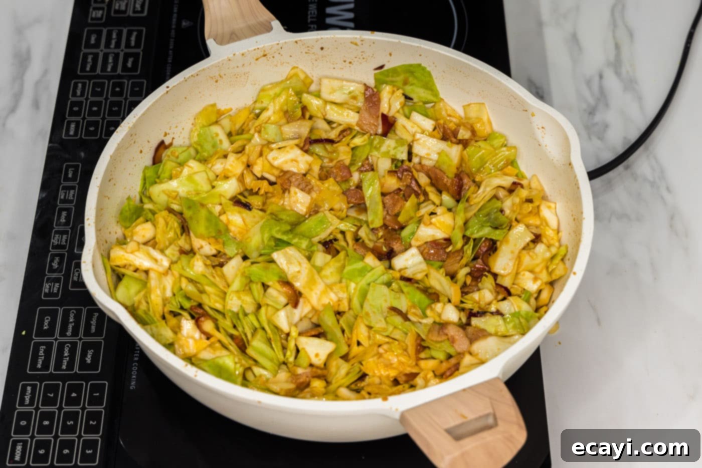 Sizzling Spicy Cabbage 8 Spicy fried cabbage fully cooked in a skillet, tender and coated in savory sauce, garnished with seasonings.