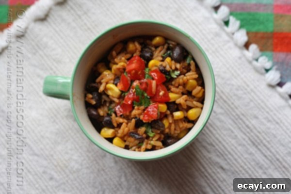 Fiesta Rice with Black Beans and Corn 3 An overhead photo of Spanish rice with black beans and corn in a teal and white bowl.