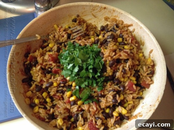 Fiesta Rice with Black Beans and Corn 9 A bowl of Spanish rice with black beans, corn and cilantro on top.