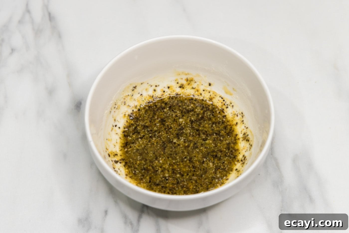 Perfectly Steamed Asparagus 5 Seasonings mixed with olive oil in a small bowl, ready for asparagus