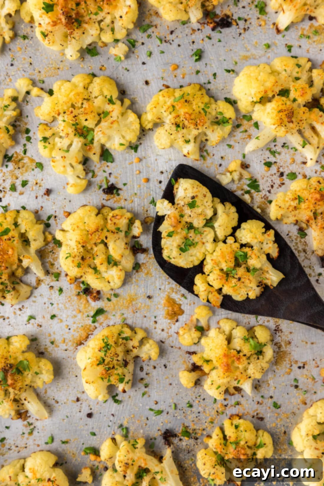 Crispy Smashed Cauliflower 3 Close up photo of Smashed Cauliflower on a sheet pan with a spatula
