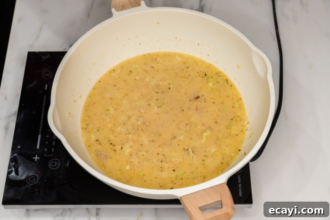 Vibrant Spinach Fettuccine 8 Creamy pasta sauce simmering gently in a skillet, showcasing its rich texture