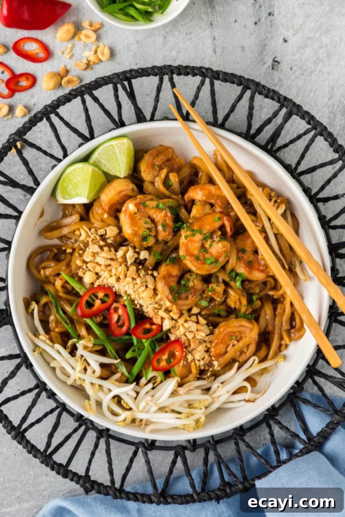 Authentic Shrimp Pad Thai 2 Bowl of homemade Shrimp Pad Thai with chopsticks, garnished with fresh herbs and peanuts