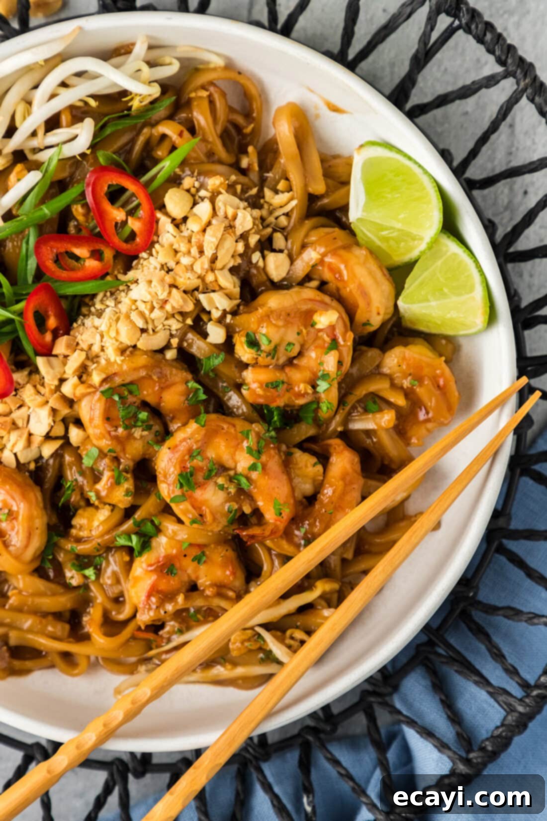Authentic Shrimp Pad Thai 3 Close up photo of freshly made Shrimp Pad Thai in a bowl with chopsticks resting on the side