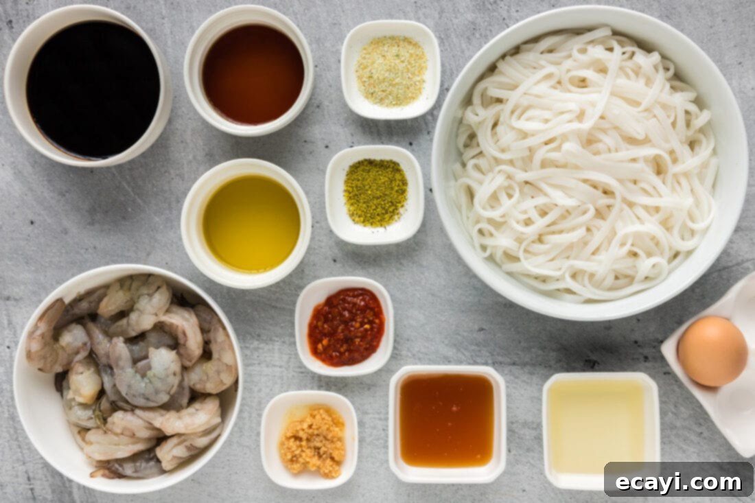 Authentic Shrimp Pad Thai 4 Various ingredients laid out for preparing Shrimp Pad Thai, including shrimp, noodles, sauce components, and an egg