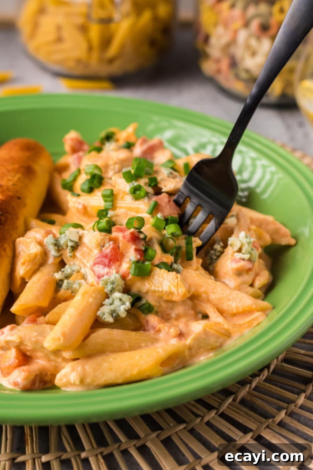 Zesty Buffalo Chicken Pasta 2 Fork stuck in a portion of Buffalo Chicken Pasta on a plate, showcasing its creamy texture