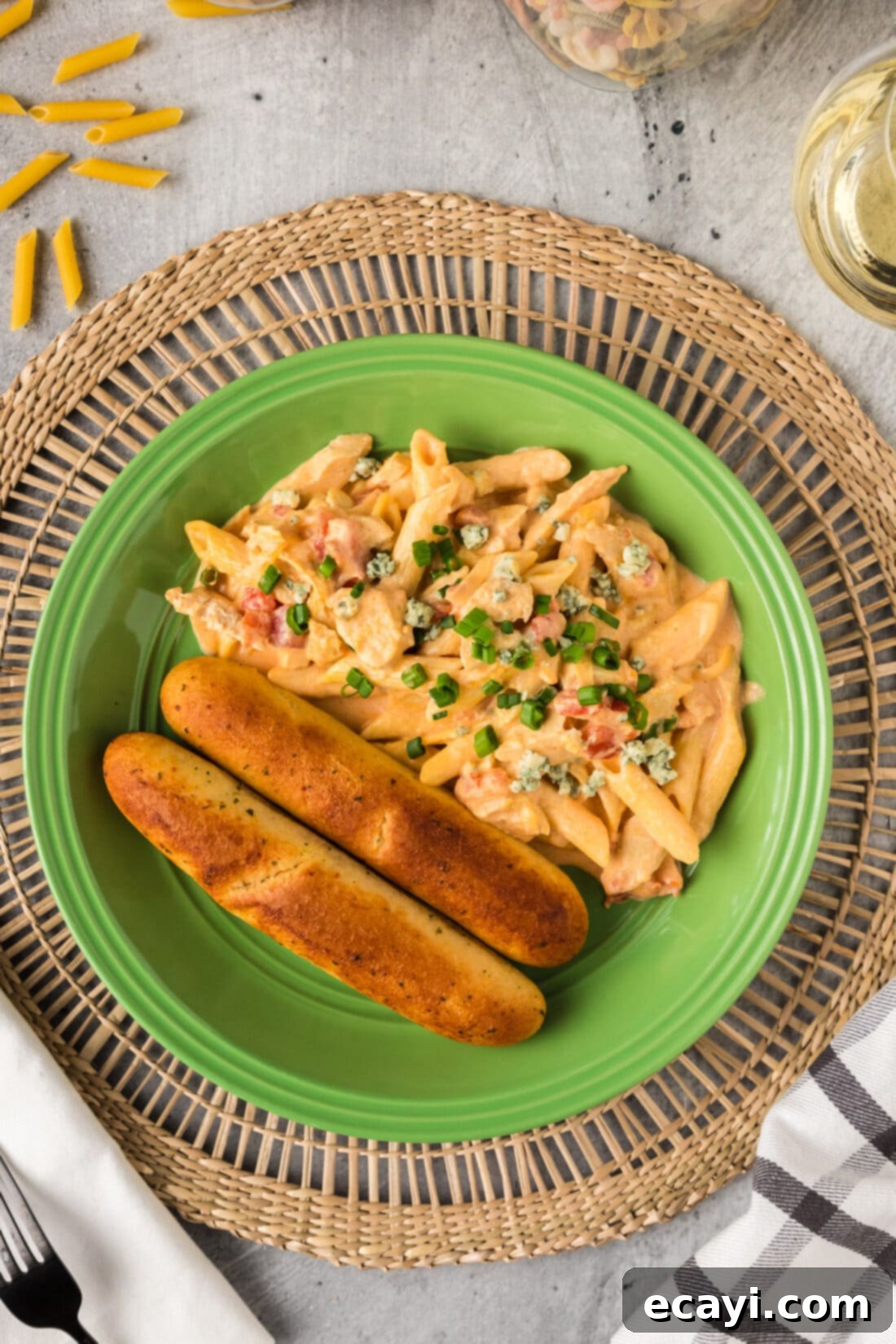 Zesty Buffalo Chicken Pasta 3 Buffalo Chicken Pasta on a plate with fresh parsley garnish and breadsticks
