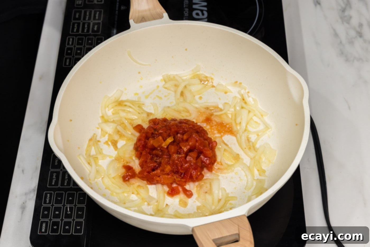 Zesty Buffalo Chicken Pasta 6 diced tomatoes added to skillet with onion and garlic