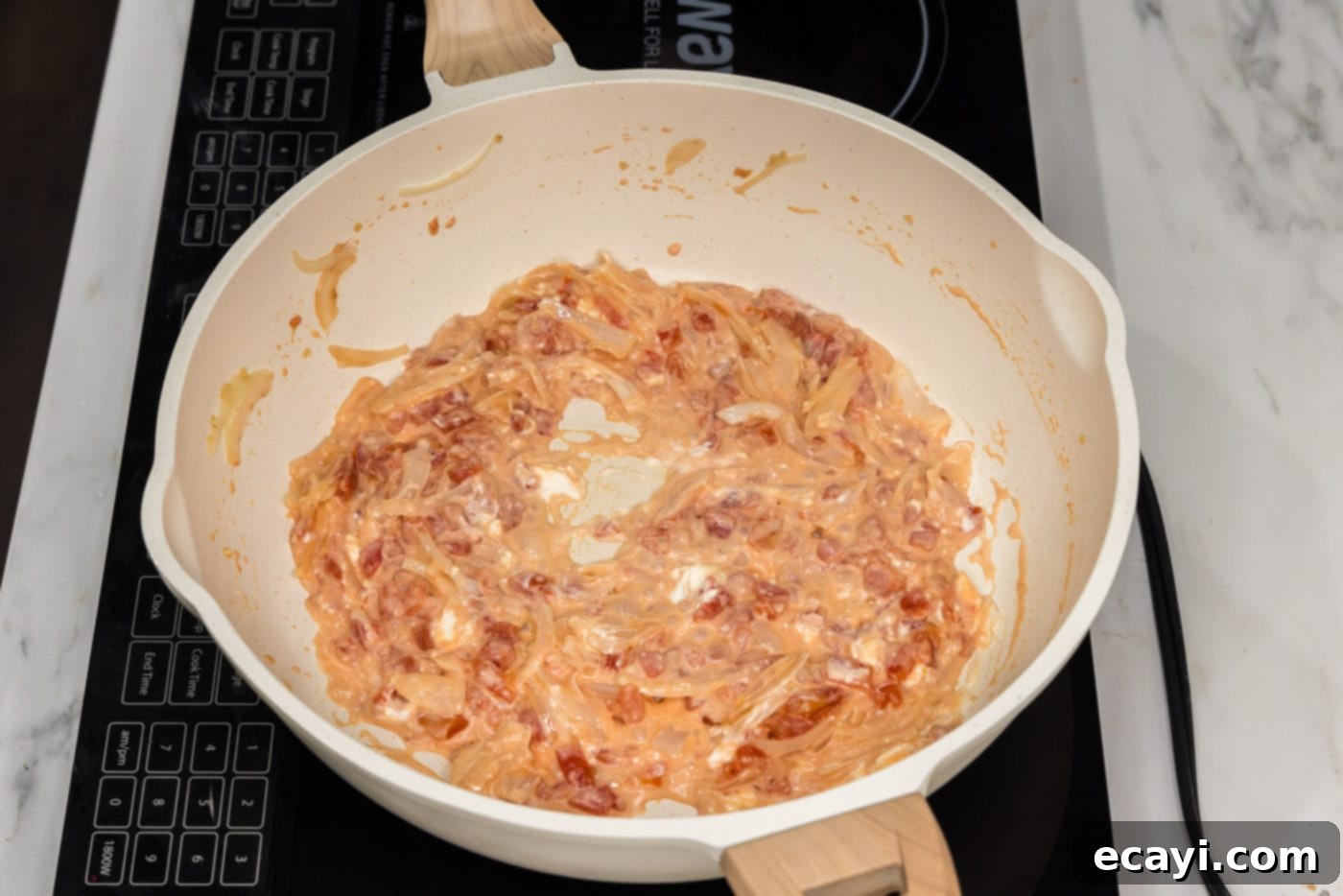 Zesty Buffalo Chicken Pasta 7 cream cheese stirred into tomatoes and onions in a skillet