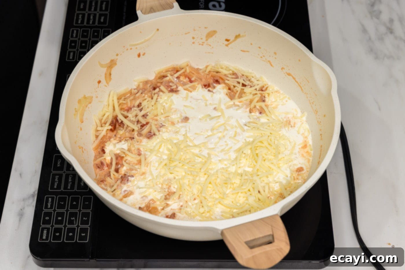 Zesty Buffalo Chicken Pasta 8 heavy cream added to skillet with cheese, tomatoes, and cream cheese