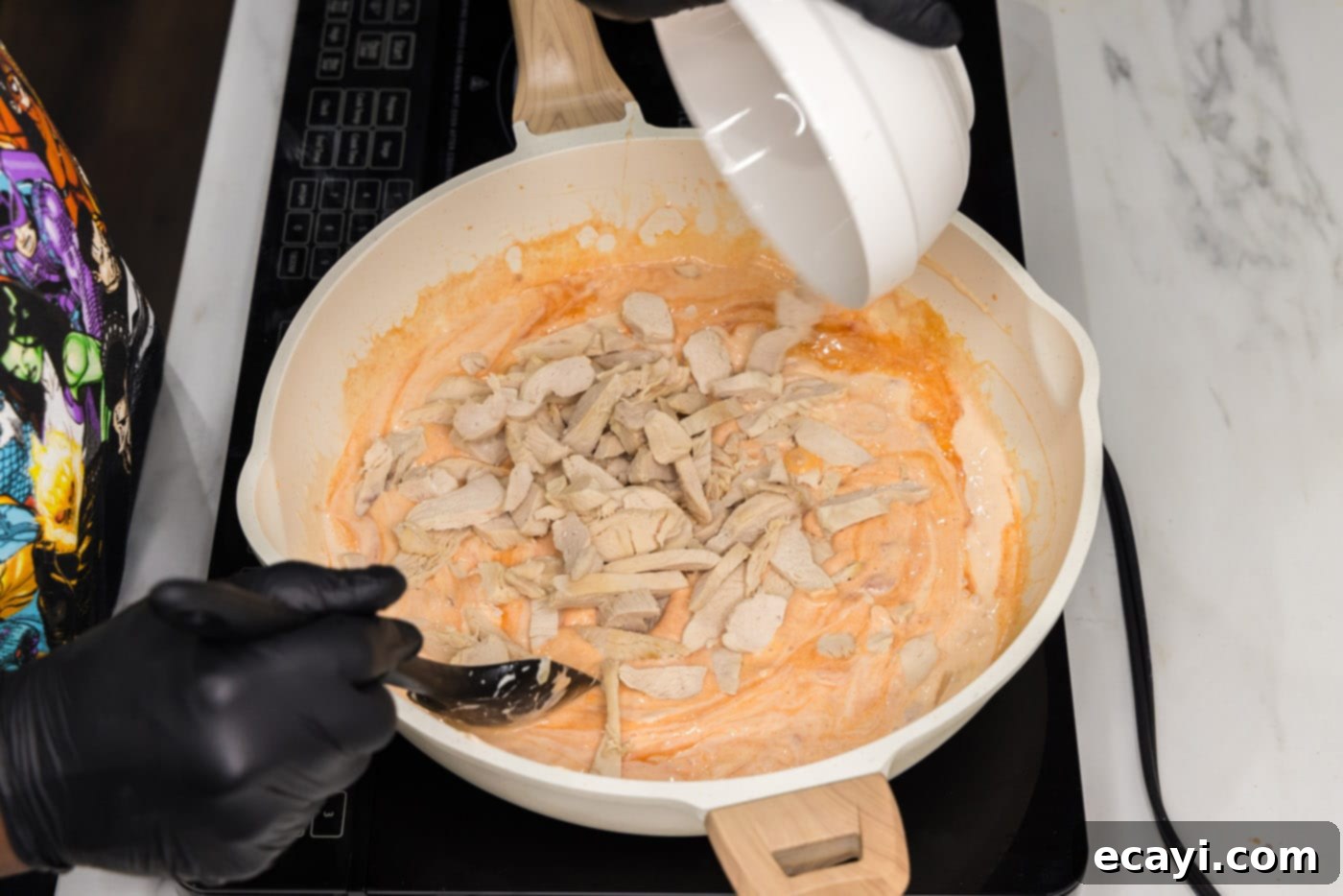 Zesty Buffalo Chicken Pasta 10 stirring chicken into skillet with creamy buffalo sauce