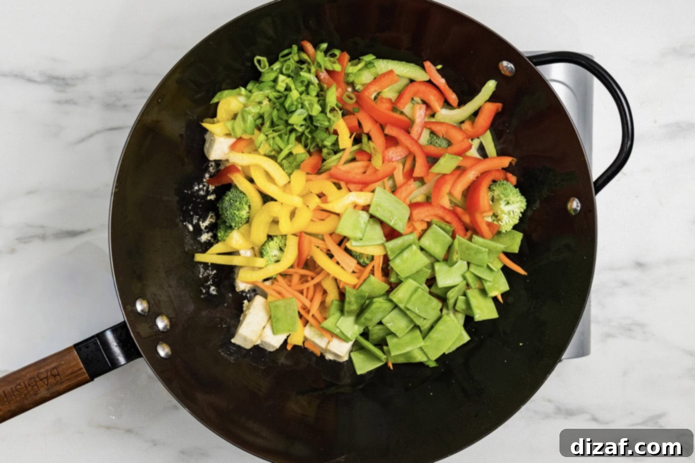 stir fry vegetables in a wok with tofu