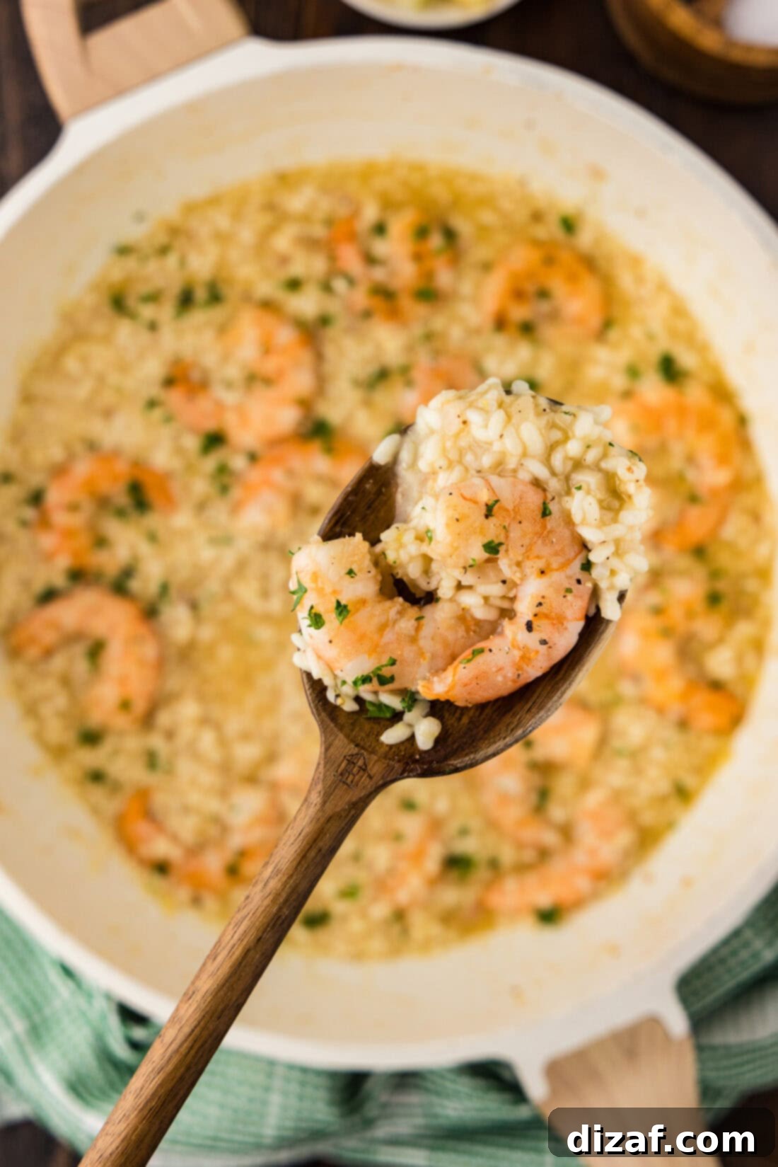Creamy Shrimp Risotto 12 Spoonful of Shrimp Risotto held above a skillet of Shrimp Risotto