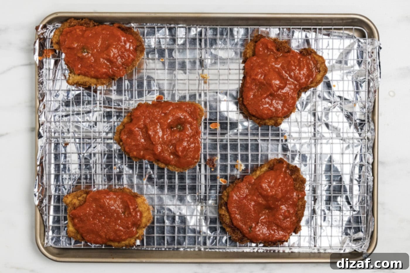 marinara sauce over cooked breaded veal cutlets