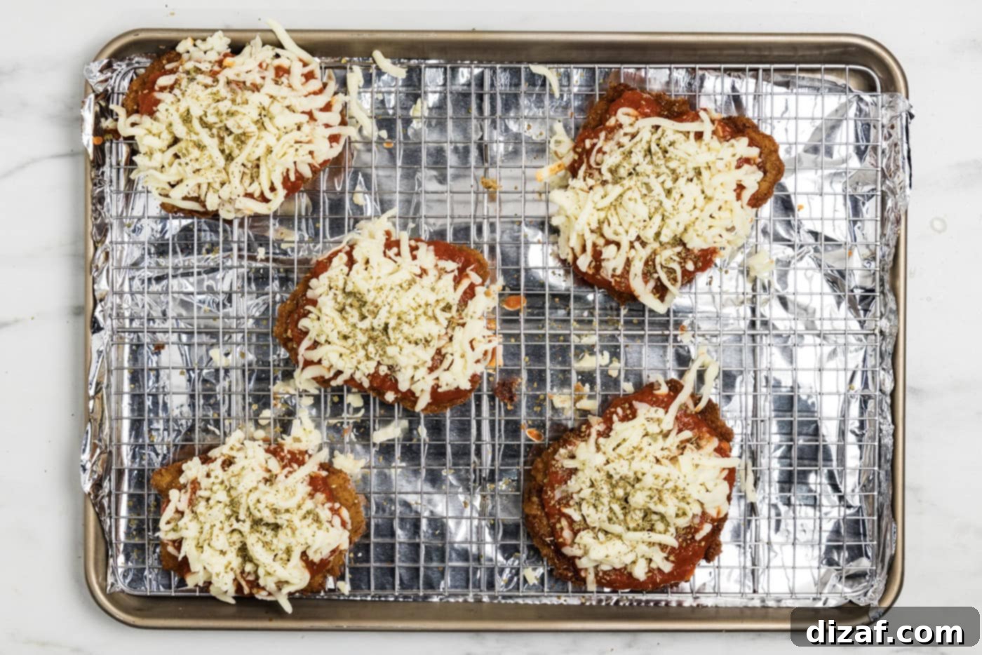 mozzarella cheese on top of marinara fried veal cutlets