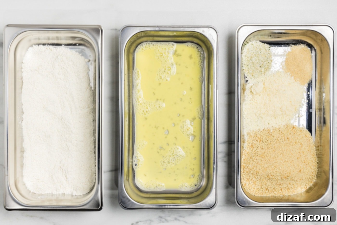 breading trays with flour in one, egg in the next, and panko bread crumb mixture in the third.