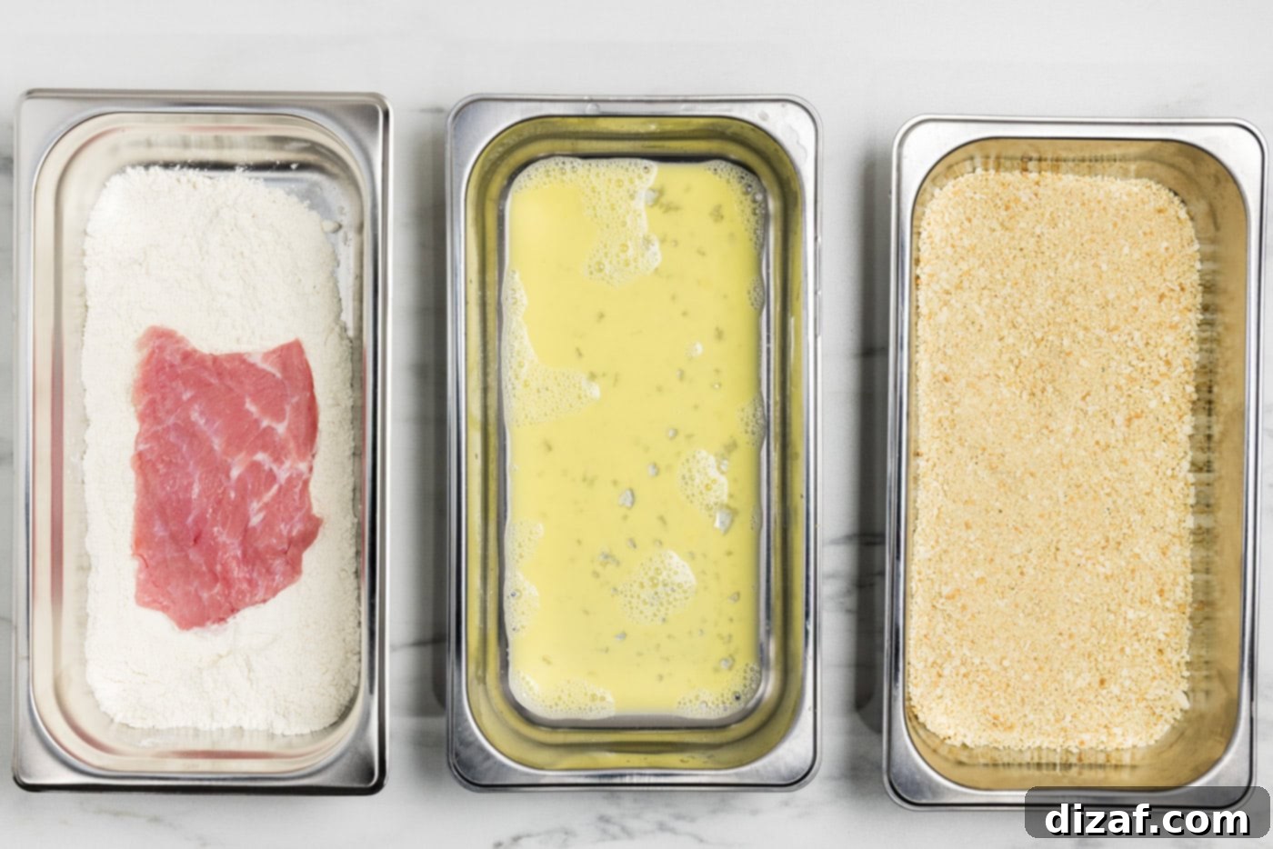 Veal cutlets in a breading pan of flour